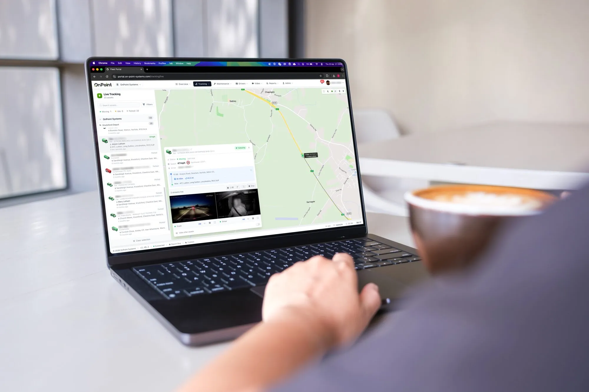 The OnPoint portal showing live tracking on a laptop, with the fleet plotted on a map